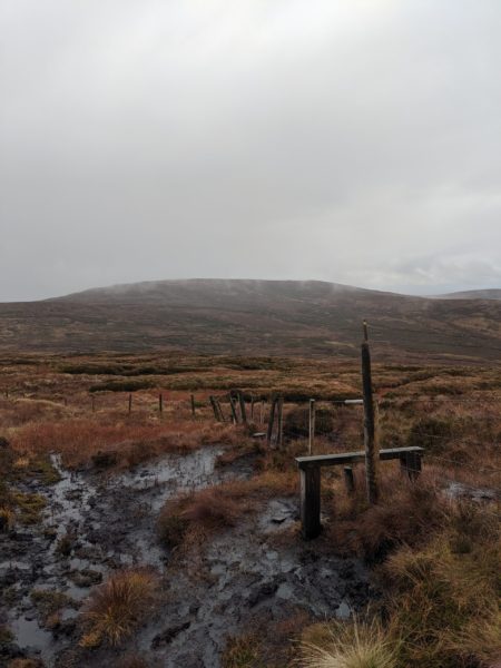 While only 550 metres, Trostan - the highest point in County Antrim - is still a testing climb, especially in the wet, as can be seen from this mud-surrounded but beautiful stile. But the variety on the way up from forest through open country and bogland to a surprisingly desolate top really does reward you when hiking Northern Ireland
