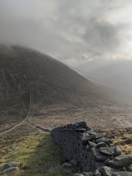 As this stunning view from the descent of Meelbeg looking back at Bearnagh shows, the light and climate can be dramatic in the Mournes - which gives great photo opportunities but makes hiking responsibly with a knowledgeable qualified guide essential. Don't settle for anything less