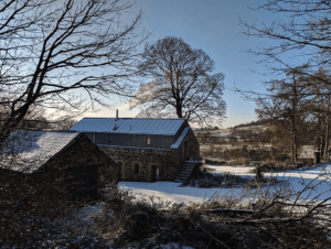 It doesn't often snow in Northern Ireland's temperate climate but even with a surrounding snow among the bare trees, the Copper Barn still looks enticing, with the smoke from the fire drifting gently upwards into the blue sky