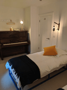 As you cannot hike all the time, there is even a piano in the guest twin room - alongside locally made beds, linens, throws, lights, hangers and hookrails