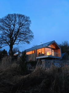 As dusk falls, the warm subtle lighting inside the Copper Barn beckons you in, urging you to kick your shoes off and get comfortable on that locally made sofa